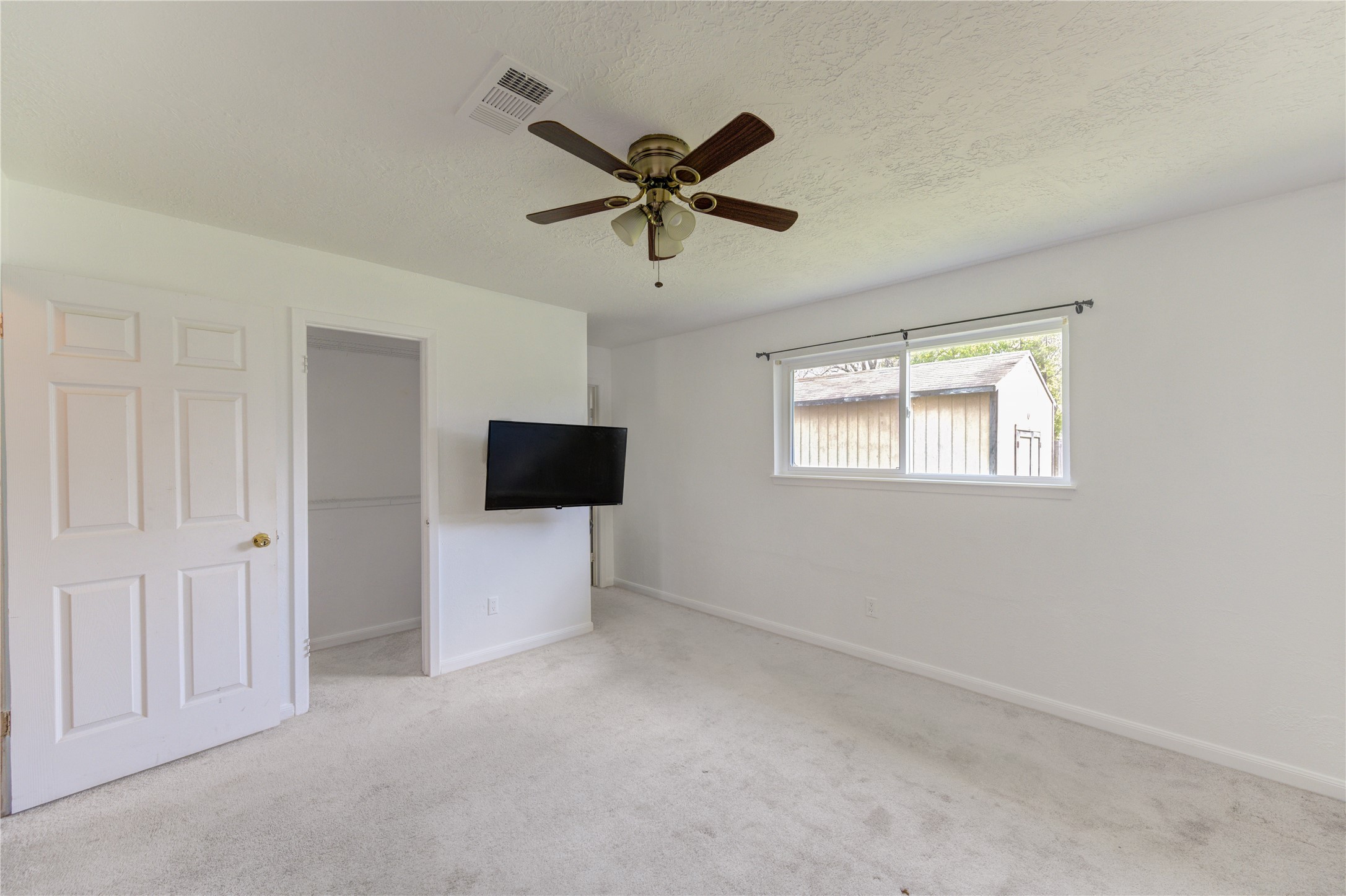 8610 Bluebonnet Street Highlands, TX 77562 - Photo 26 of 45 a living room with a ceiling fan and a window