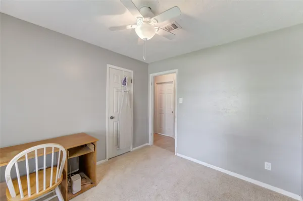a view of an empty room with a fan