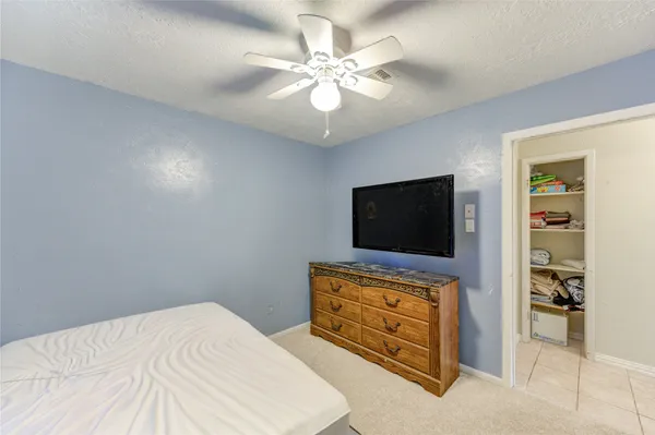 a bedroom with furniture and a flat screen tv