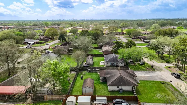 an aerial view of residential house with outdoor space and trees