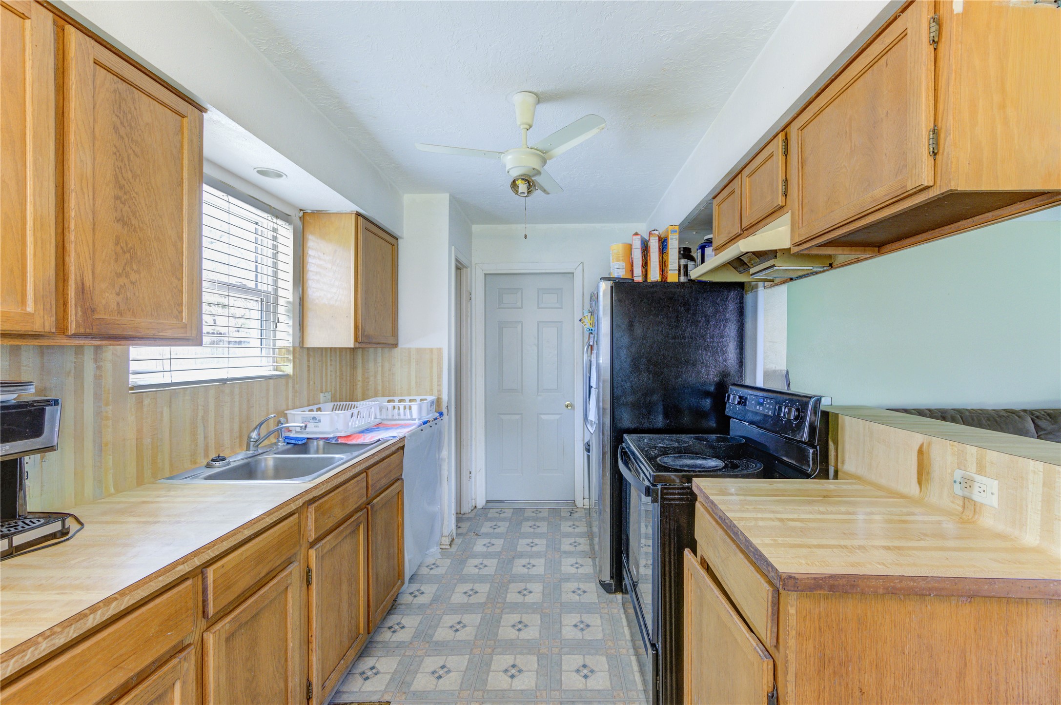 8610 Bluebonnet Street Highlands, TX 77562 - Photo 10 of 45 a kitchen that has a sink and a stove