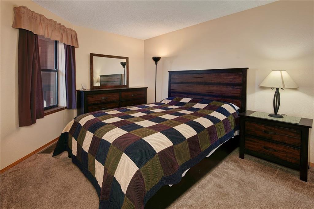 520 Bills Ranch Road, Unit 303 Frisco, CO 80443 - Photo 12 of 25 a bedroom with a bed and a night stand