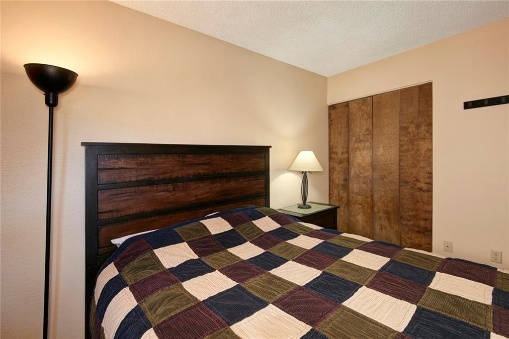 520 Bills Ranch Road, Unit 303 Frisco, CO 80443 - Photo 13 of 25 a bedroom with a bed and a lamp on the dresser