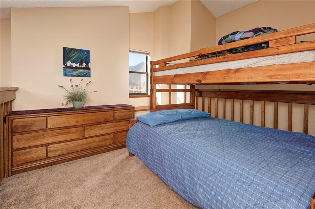 520 Bills Ranch Road, Unit 303 Frisco, CO 80443 - Photo 18 of 25 a bedroom with a bed and wooden floor
