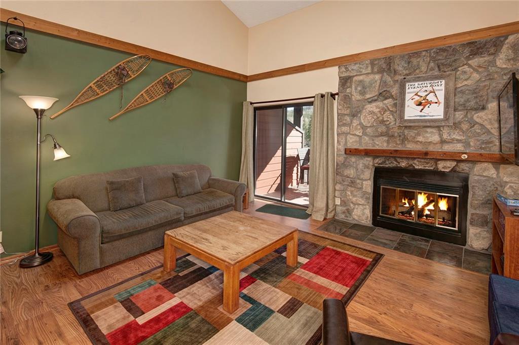 520 Bills Ranch Road, Unit 303 Frisco, CO 80443 - Photo 3 of 25 a living room with furniture a flat screen tv and a fireplace