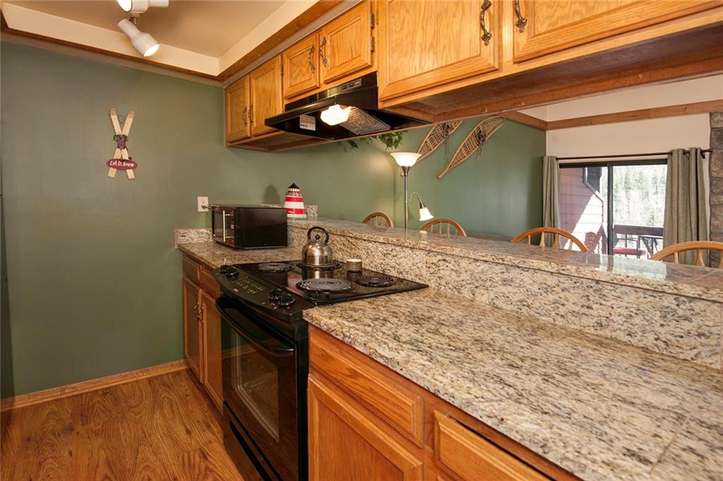 520 Bills Ranch Road, Unit 303 Frisco, CO 80443 - Photo 9 of 25 a kitchen with stainless steel appliances granite countertop a sink stove and cabinets