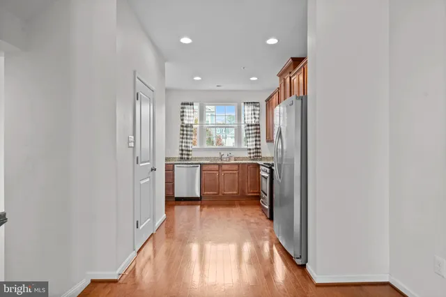 a view of a kitchen with a sink and wooden floor