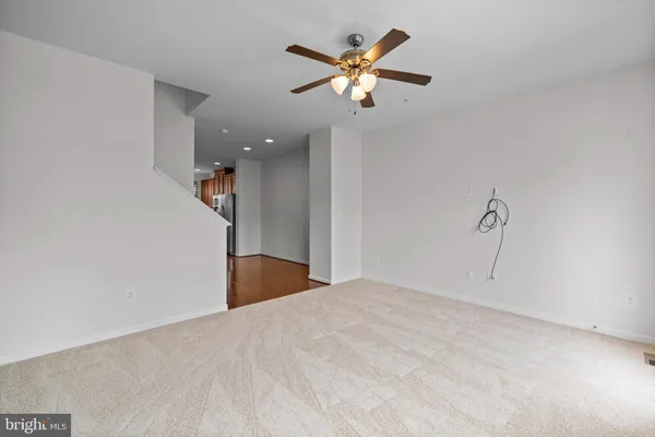 a view of a livingroom with a ceiling fan and a chandelier fan