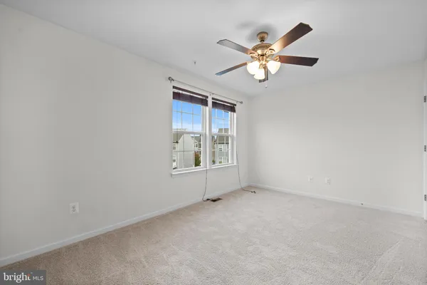 a view of room with window and ceiling fan