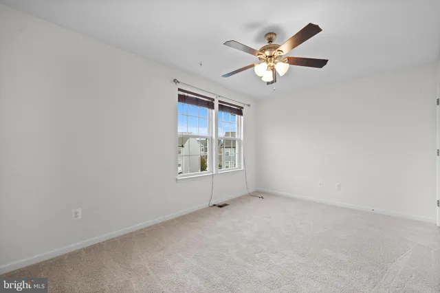 a view of room with window and ceiling fan