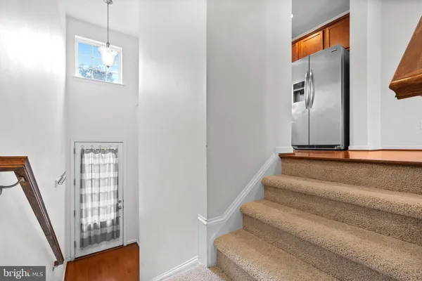 a view of staircase with white walls and a window