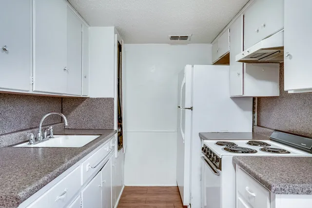 a kitchen with a stove and a refrigerator