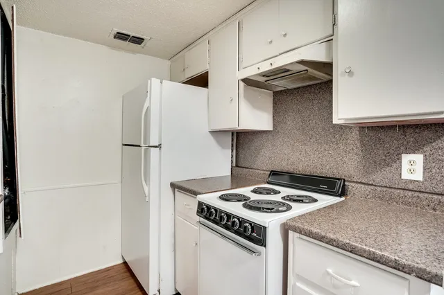 a kitchen with a stove and a refrigerator