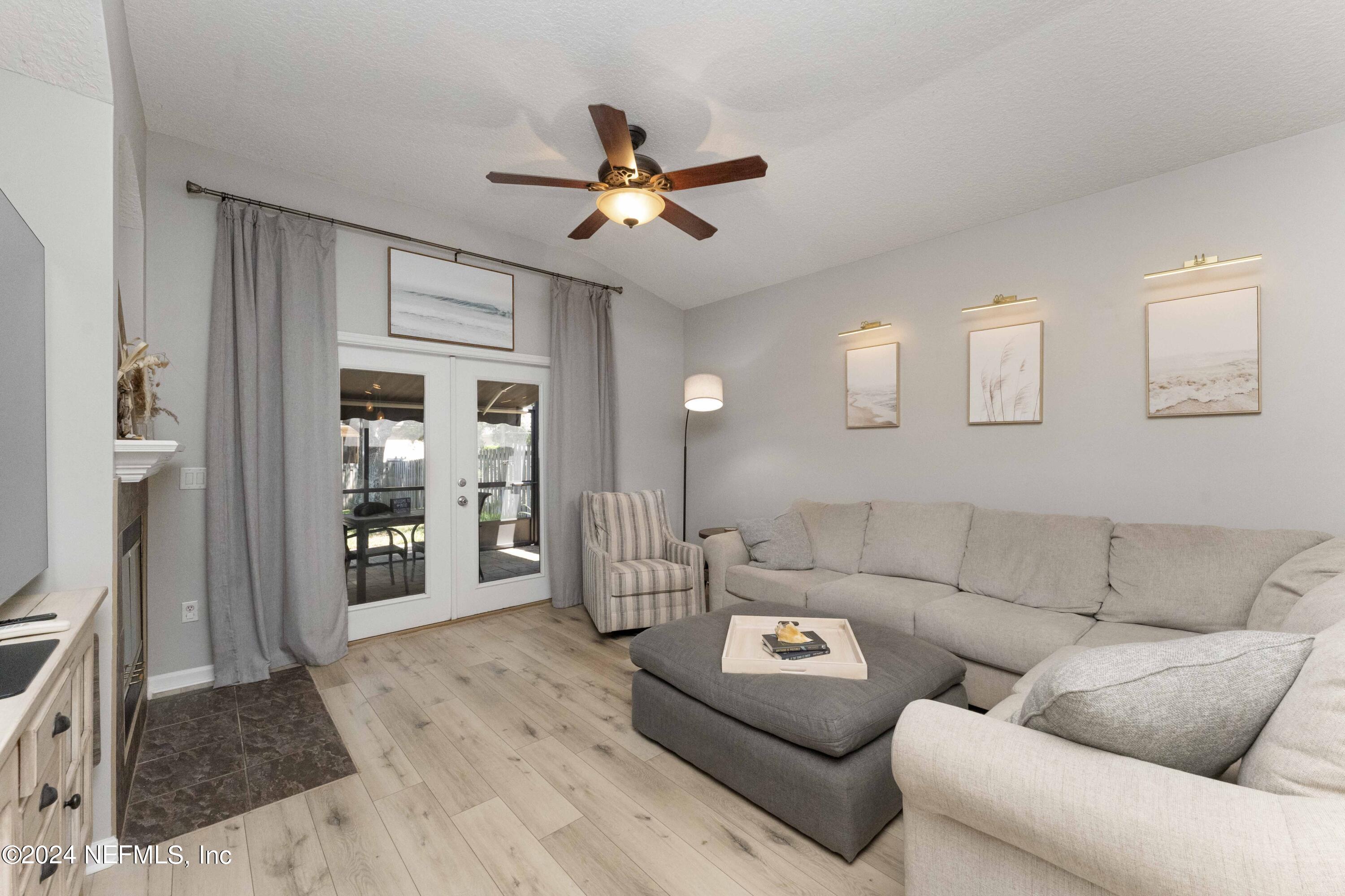 14498 Falling Waters Drive Jacksonville, FL 32258 - Photo 13 of 54 a living room with furniture and a chandelier