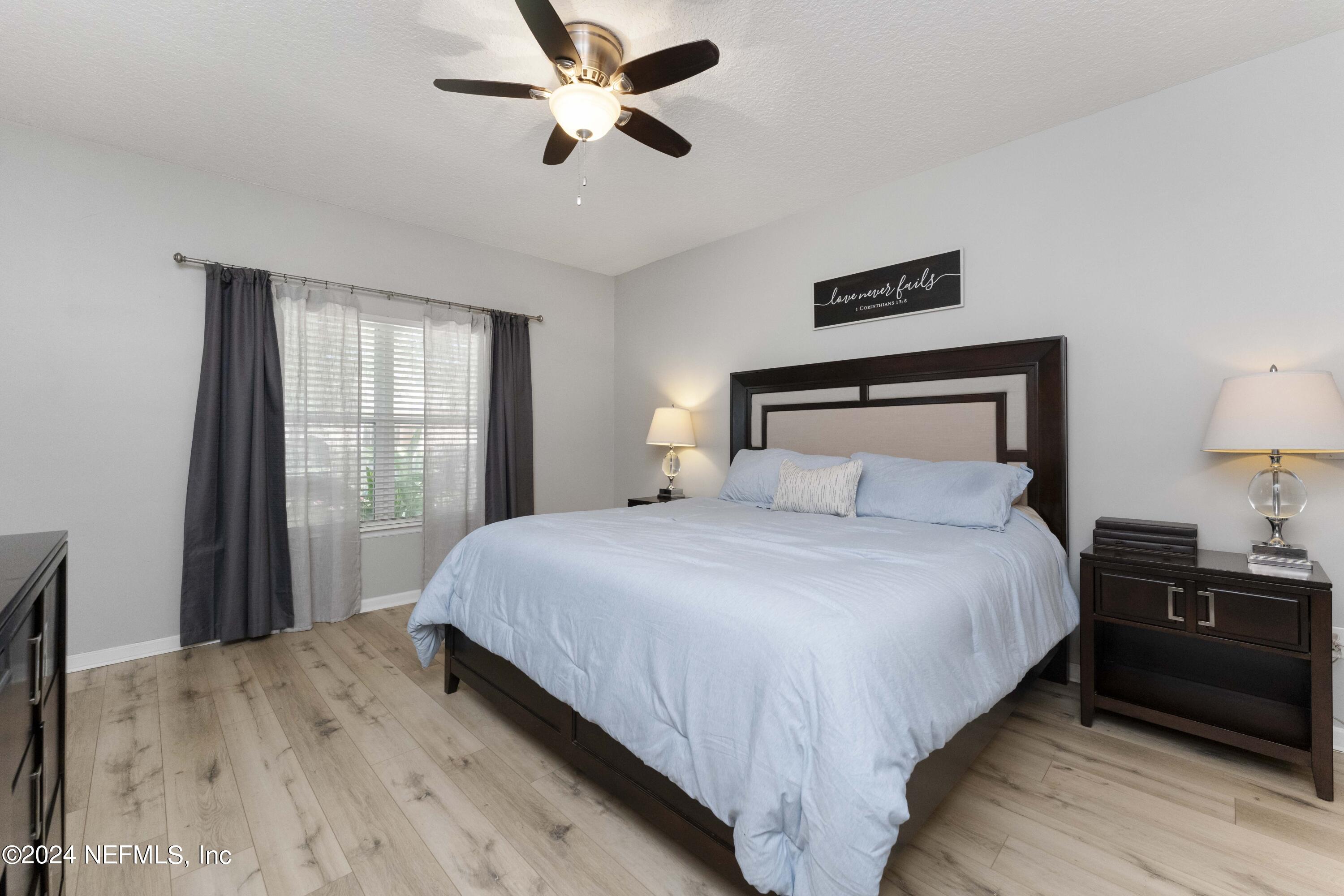 14498 Falling Waters Drive Jacksonville, FL 32258 - Photo 16 of 54 a bedroom with a bed and wooden floor