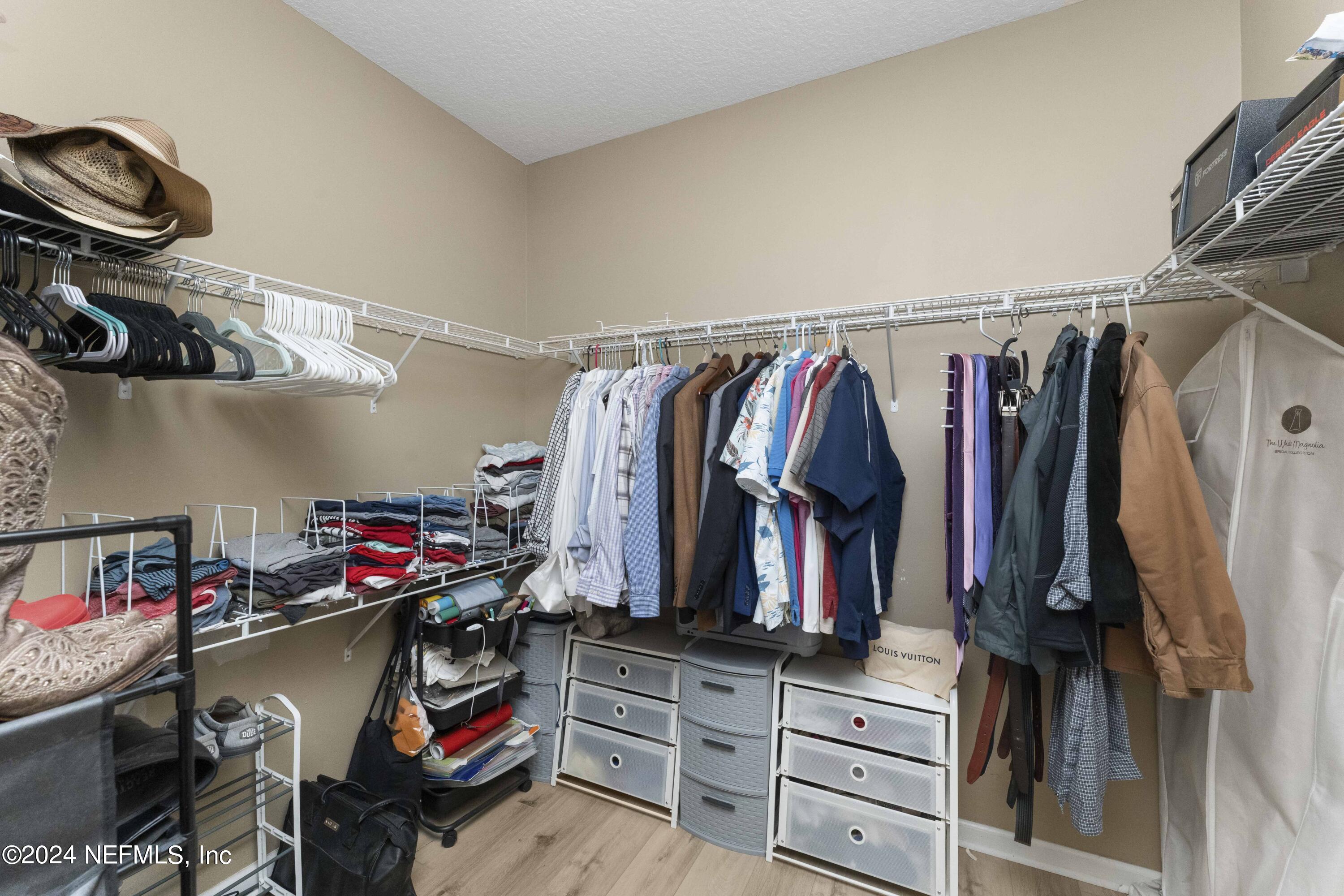 14498 Falling Waters Drive Jacksonville, FL 32258 - Photo 20 of 54 a view of walk in closet with clothes