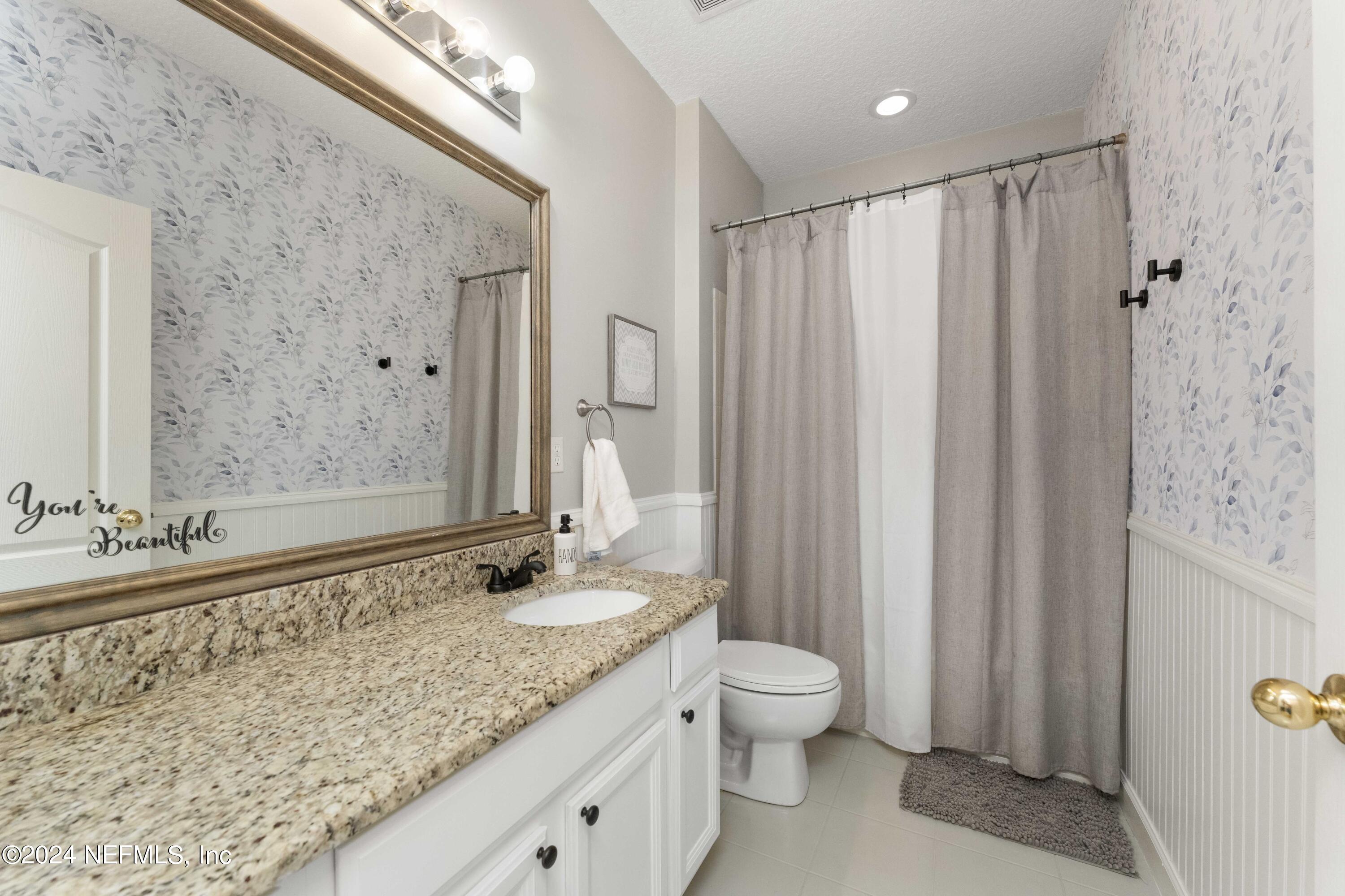14498 Falling Waters Drive Jacksonville, FL 32258 - Photo 22 of 54 a bathroom with a granite countertop sink and a mirror