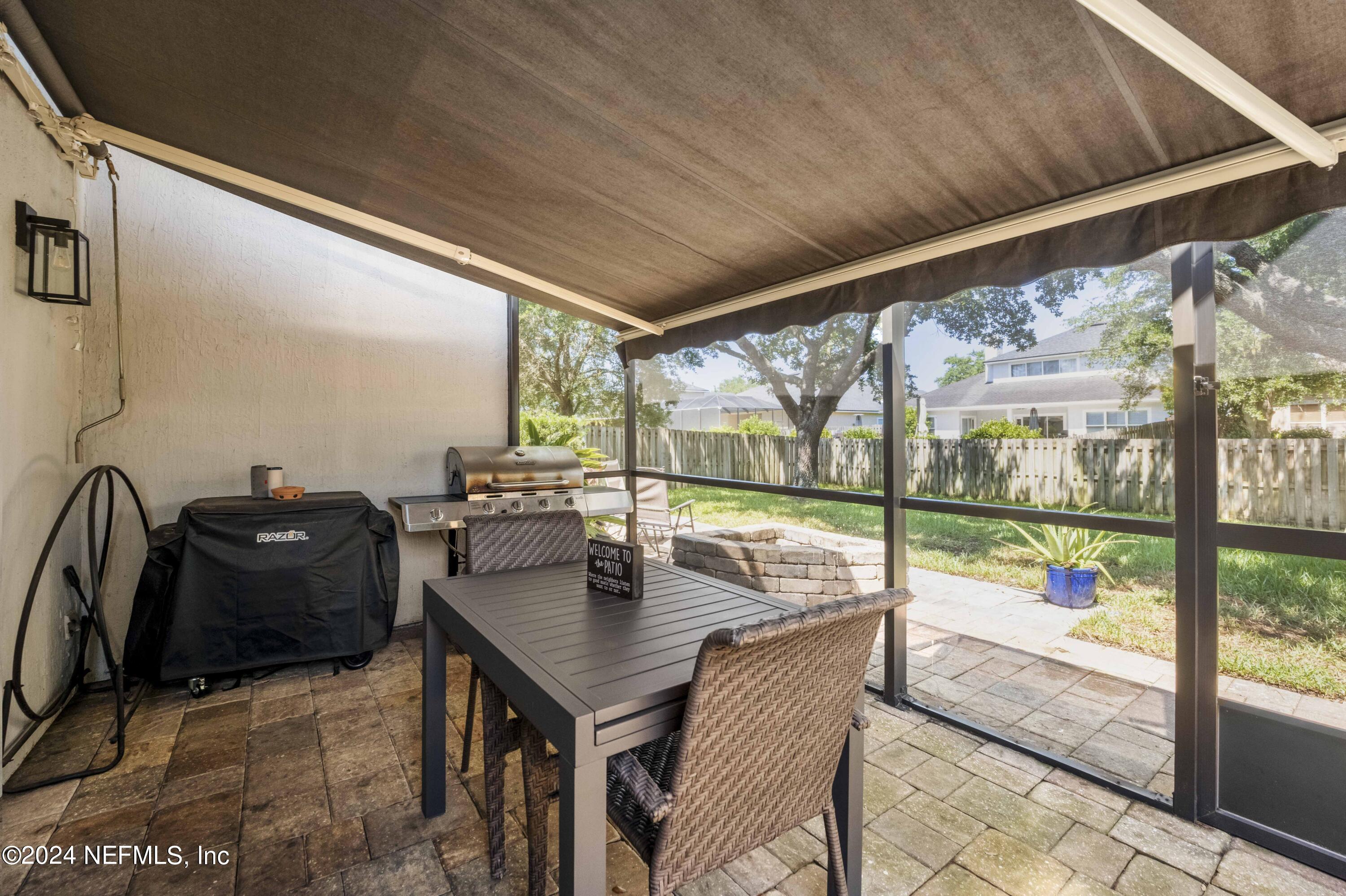 14498 Falling Waters Drive Jacksonville, FL 32258 - Photo 27 of 54 a dining room with furniture and floor to ceiling window