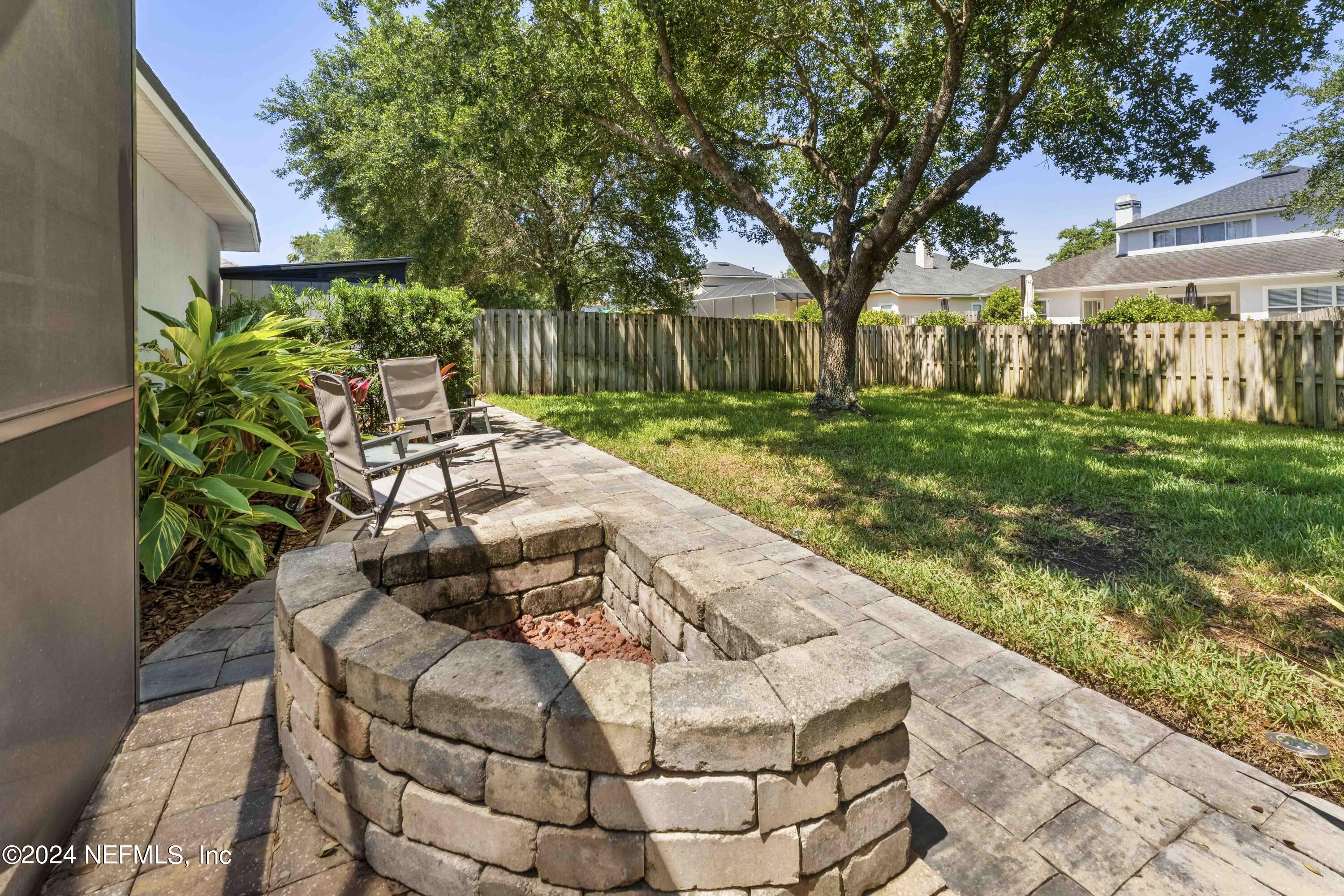 14498 Falling Waters Drive Jacksonville, FL 32258 - Photo 30 of 54 a view of a patio with table and chairs potted plants and large tree