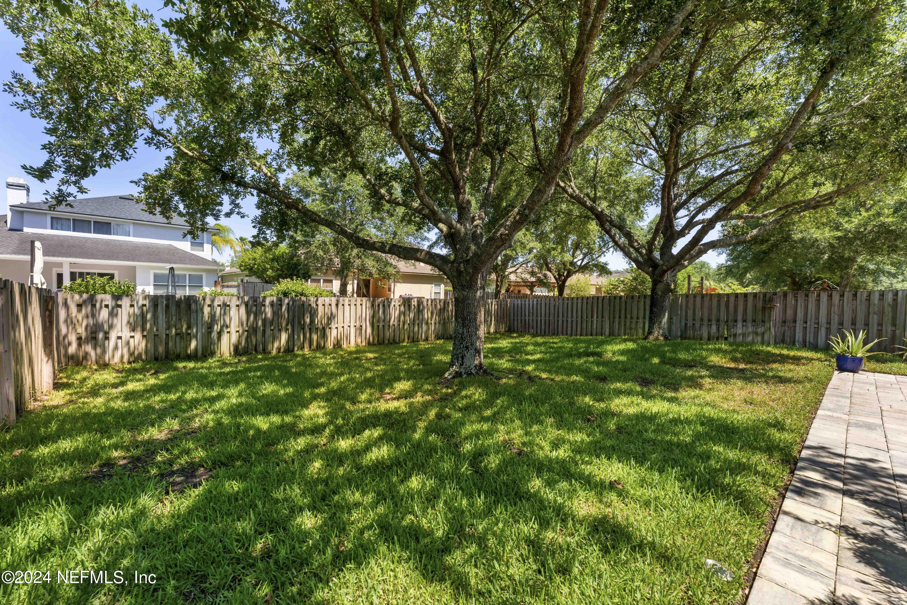 14498 Falling Waters Drive Jacksonville, FL 32258 - Photo 31 of 54 a view of backyard with a garden and trees