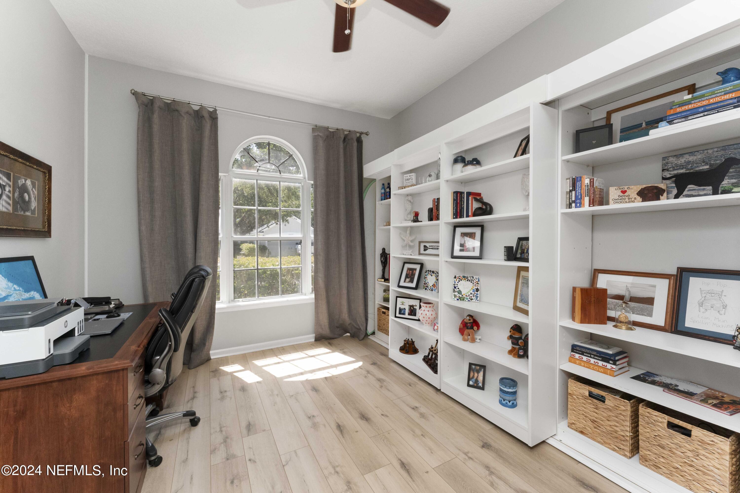 14498 Falling Waters Drive Jacksonville, FL 32258 - Photo 7 of 54 a bedroom with furniture and a book shelf