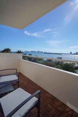 a view of a balcony with wooden floor and city view