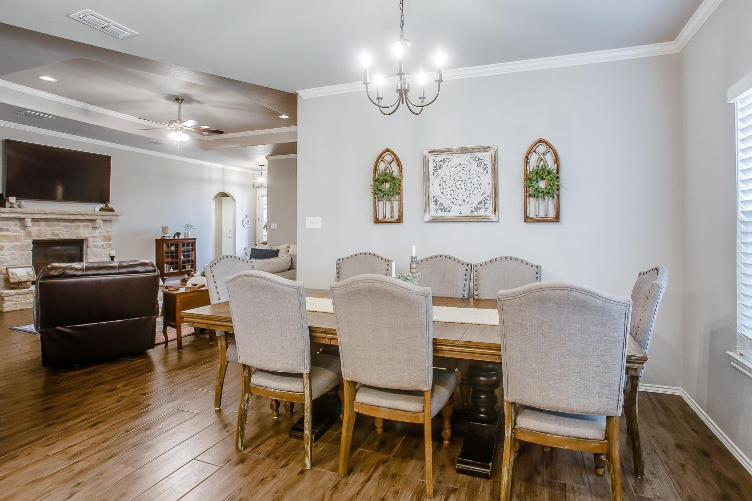 3911 127th Street Lubbock, TX 79423 - Photo 12 of 33 a view of a dining room with furniture wooden floor and chandelier