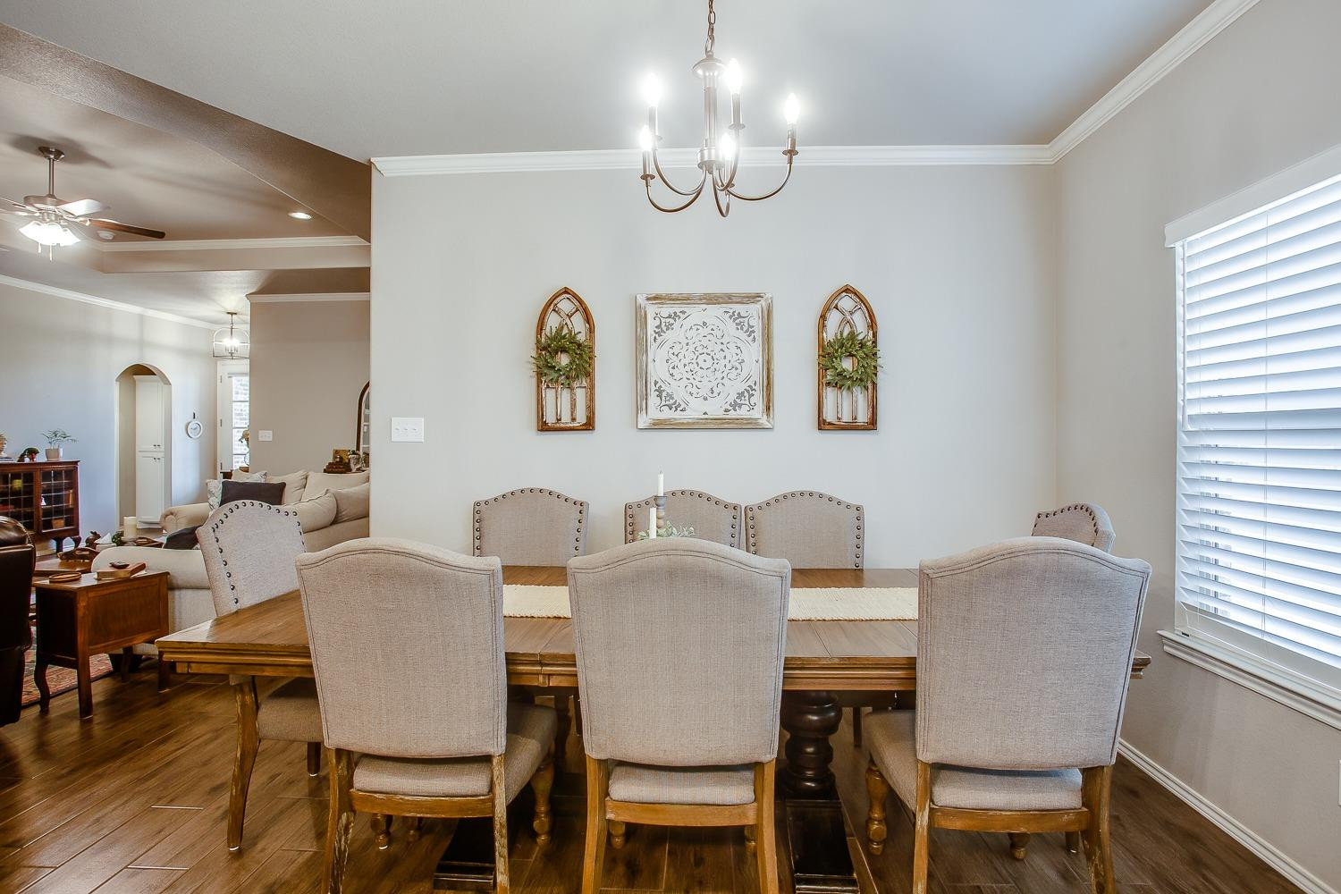 3911 127th Street Lubbock, TX 79423 - Photo 13 of 33 a view of a dining room with furniture a chandelier and wooden floor