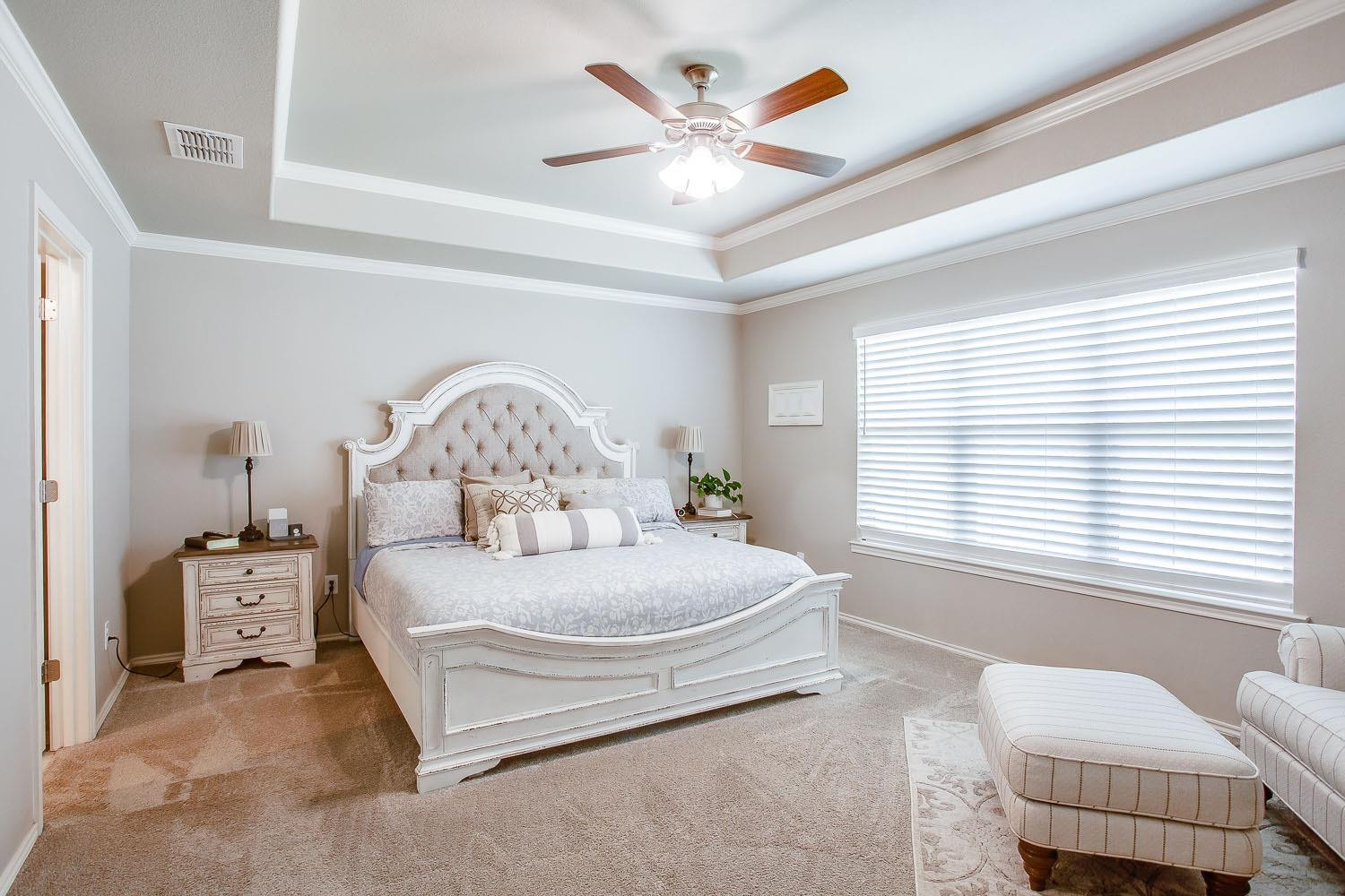 3911 127th Street Lubbock, TX 79423 - Photo 14 of 33 a spacious bedroom with a bed and a large window