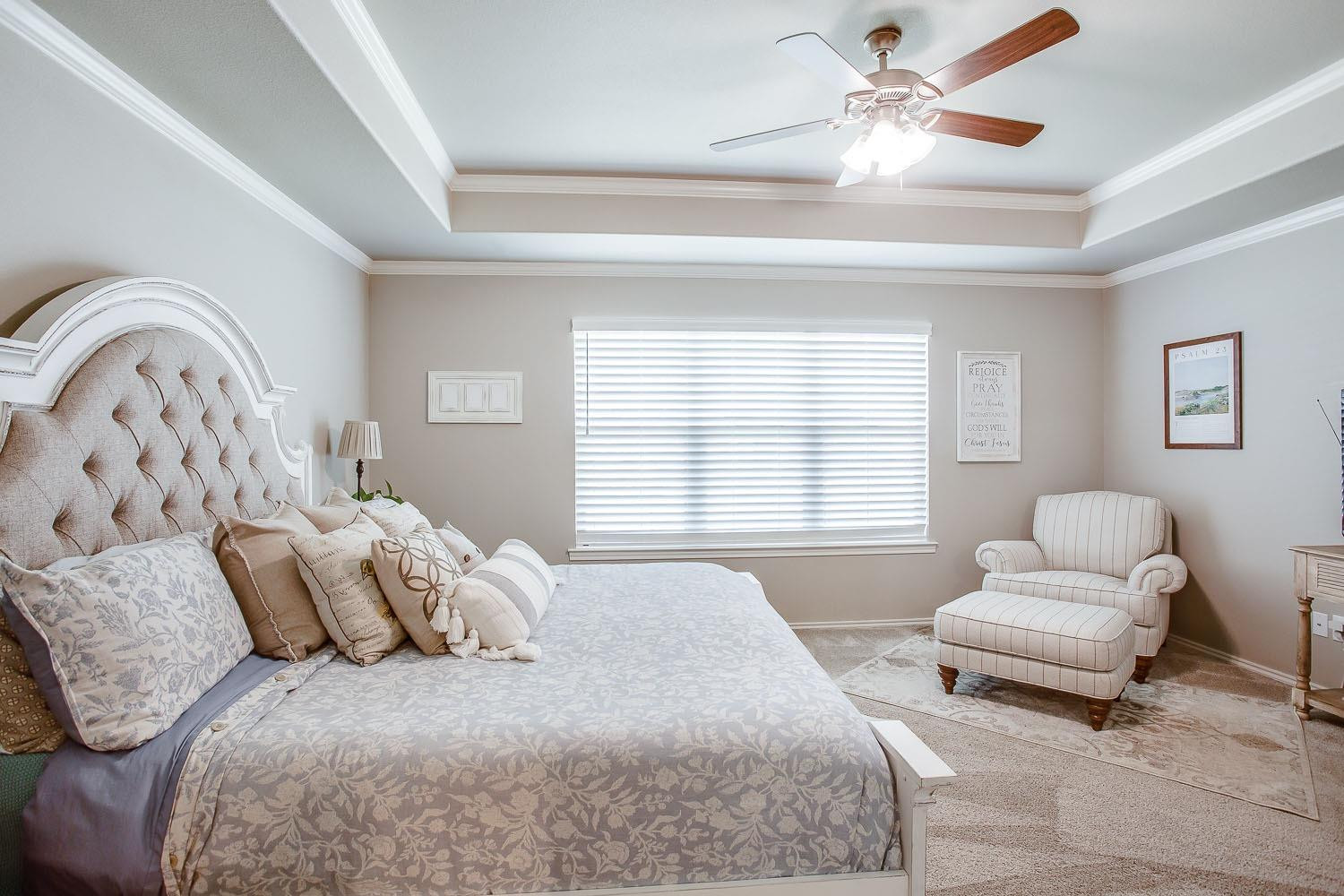 3911 127th Street Lubbock, TX 79423 - Photo 15 of 33 a spacious bedroom with a bed and ceiling fan