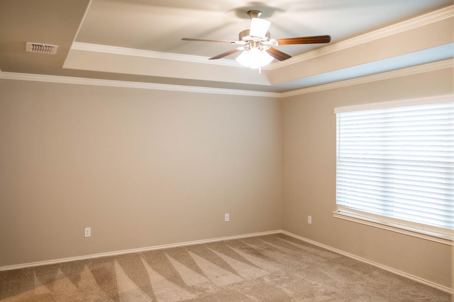 3911 127th Street Lubbock, TX 79423 - Photo 16 of 33 an empty room with a window and a fan