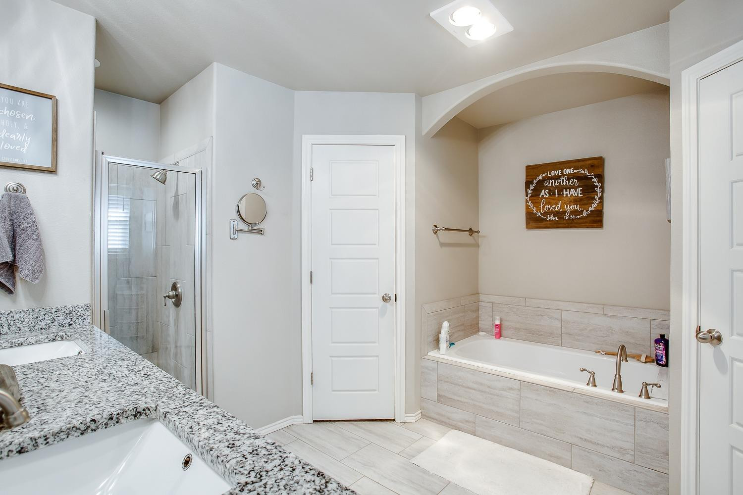 3911 127th Street Lubbock, TX 79423 - Photo 19 of 33 a bathroom with a bathtub and a sink