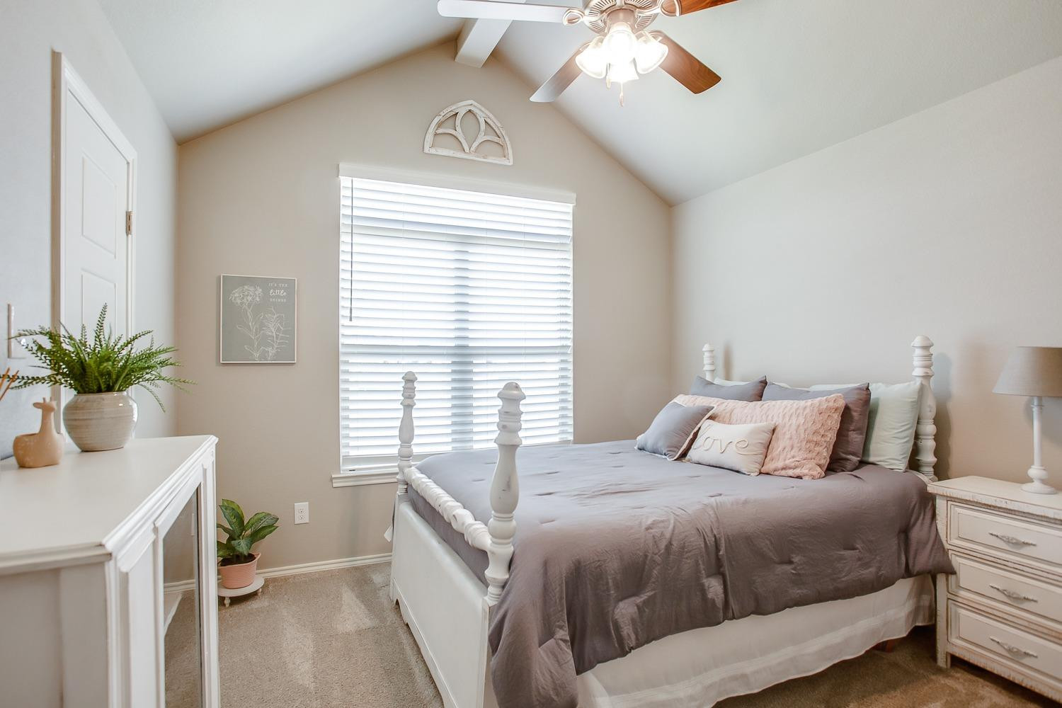 3911 127th Street Lubbock, TX 79423 - Photo 26 of 33 a bedroom with a bed and a potted plant