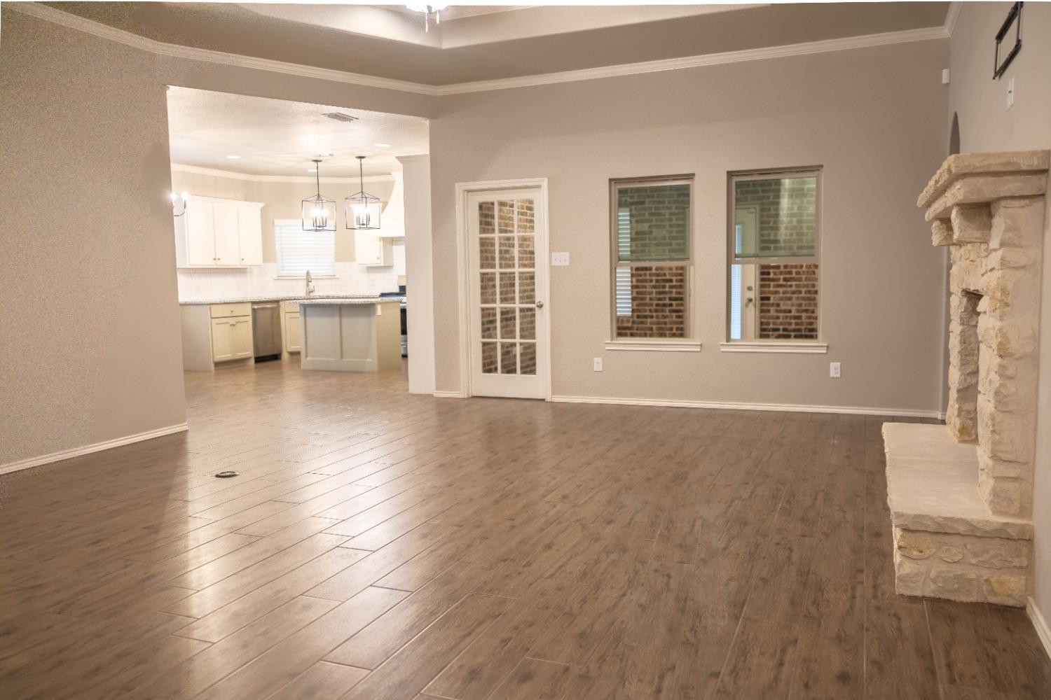 3911 127th Street Lubbock, TX 79423 - Photo 3 of 33 an empty room with wooden floor and a window