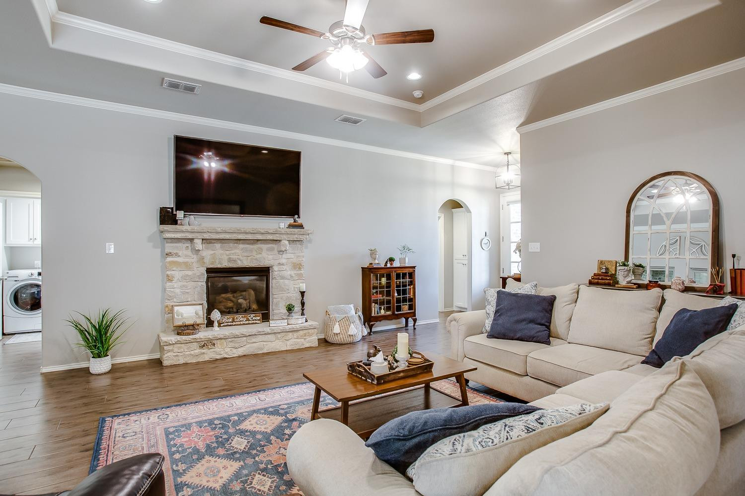 3911 127th Street Lubbock, TX 79423 - Photo 5 of 33 a living room with furniture a flat screen tv and a fireplace