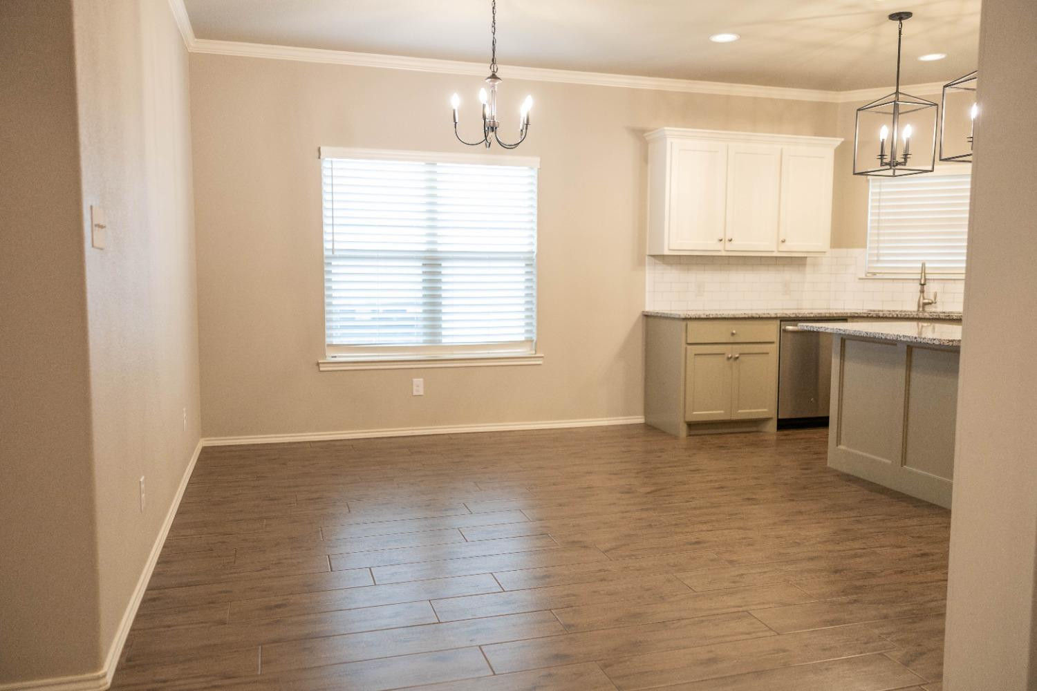3911 127th Street Lubbock, TX 79423 - Photo 8 of 33 a view of a kitchen with granite countertop cabinets and wooden floor
