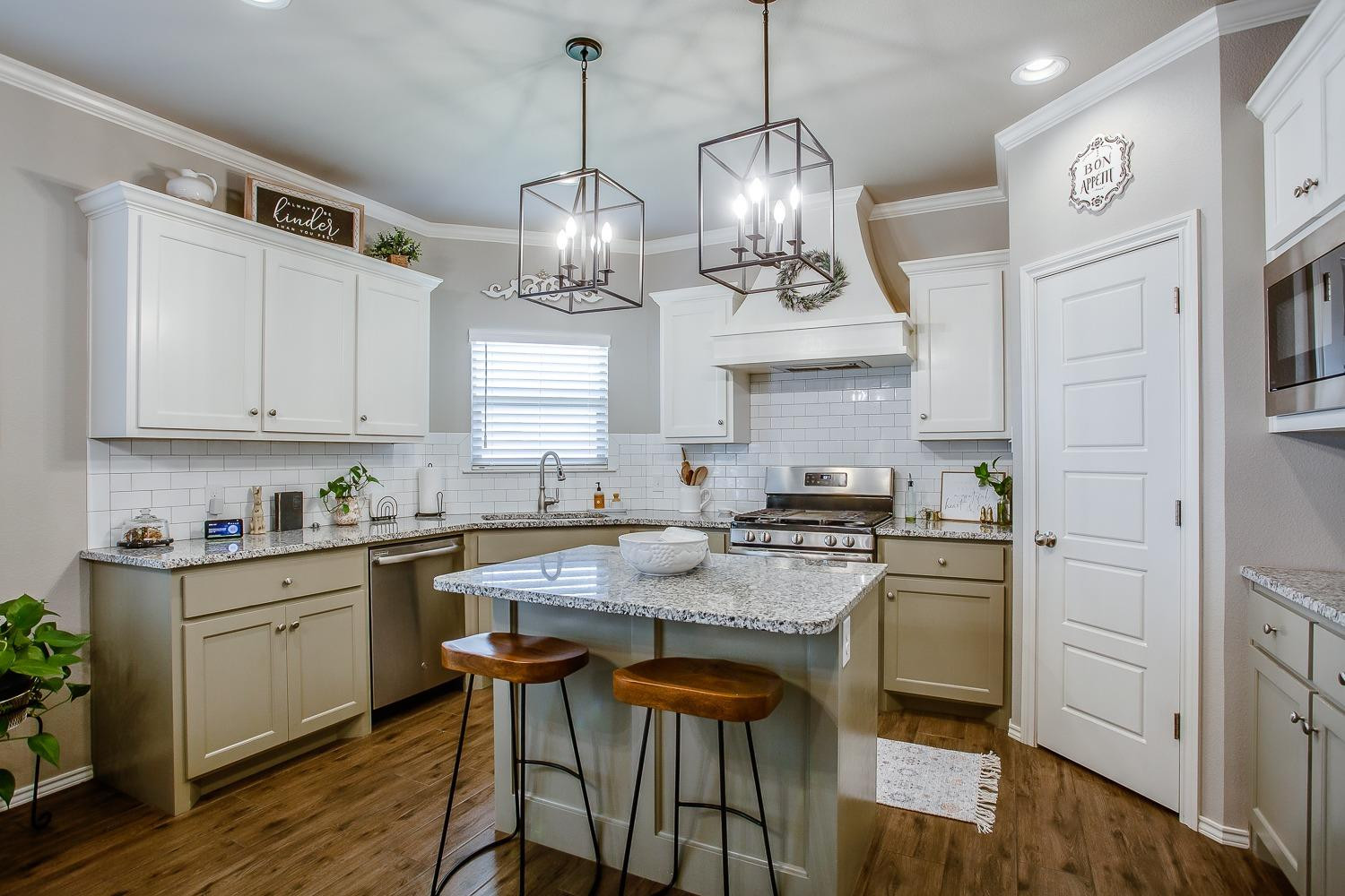 3911 127th Street Lubbock, TX 79423 - Photo 9 of 33 a kitchen with stainless steel appliances granite countertop a sink a stove and chairs