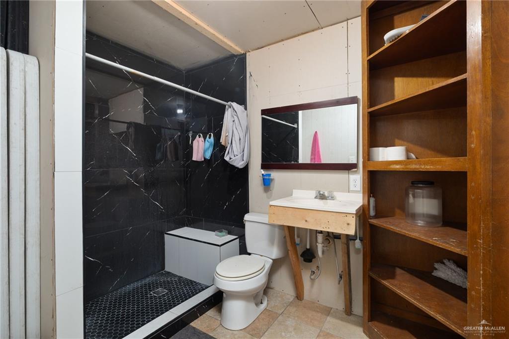 8220 Cardinal Delta Street Mission, TX 78574 - Photo 15 of 18 a bathroom with a toilet a sink and shower