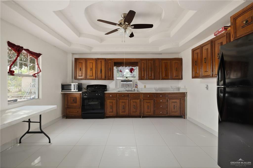 8220 Cardinal Delta Street Mission, TX 78574 - Photo 5 of 18 a kitchen with a refrigerator and a sink