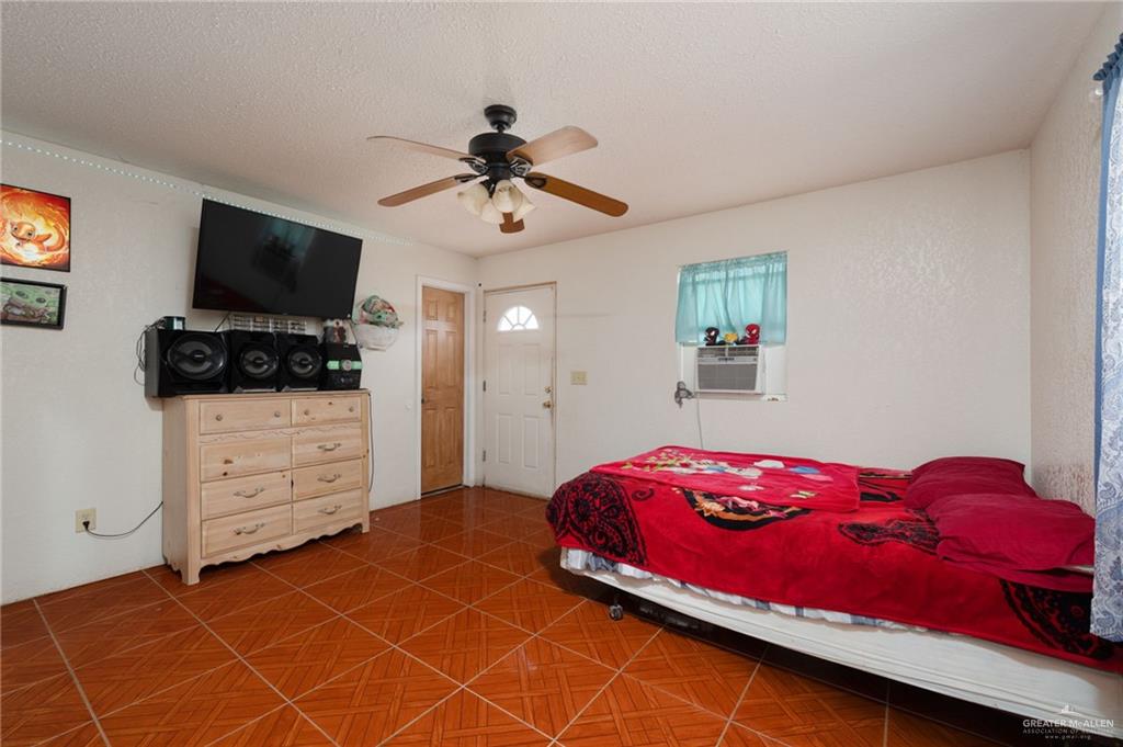 8220 Cardinal Delta Street Mission, TX 78574 - Photo 6 of 18 a bedroom with a bed and a flat screen tv