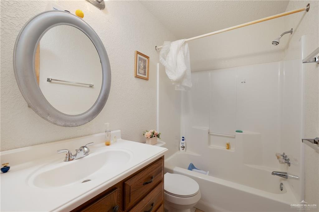 8220 Cardinal Delta Street Mission, TX 78574 - Photo 7 of 18 a bathroom with a sink a toilet and a mirror