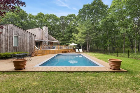 a view of a backyard with sitting area