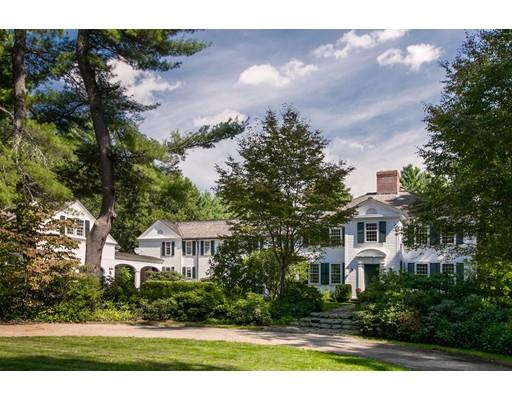 a front view of a house with a yard and a garden