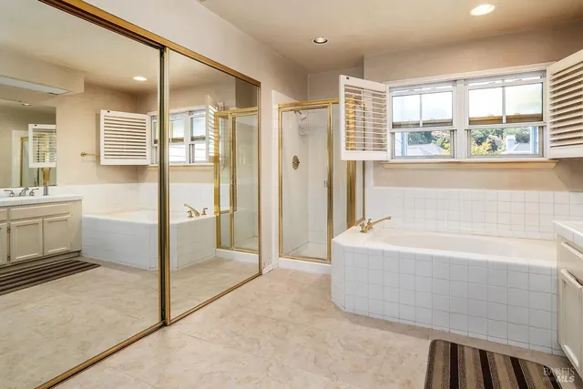 a bathroom with a bathtub and a shower