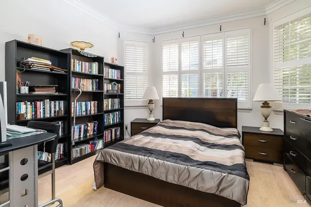 a bedroom with a bed furniture and a book shelf