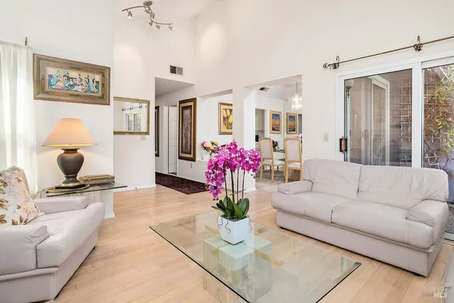 a living room with furniture and flowers