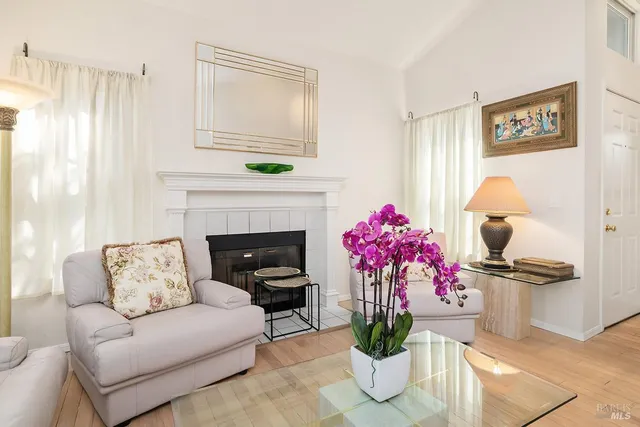 a living room with furniture and flowers