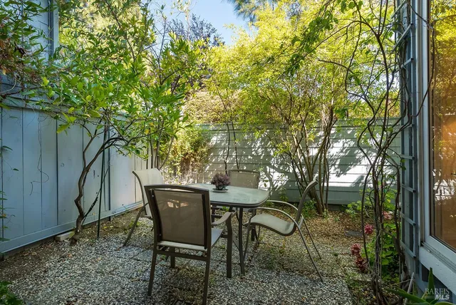 a backyard of a house with table and chairs