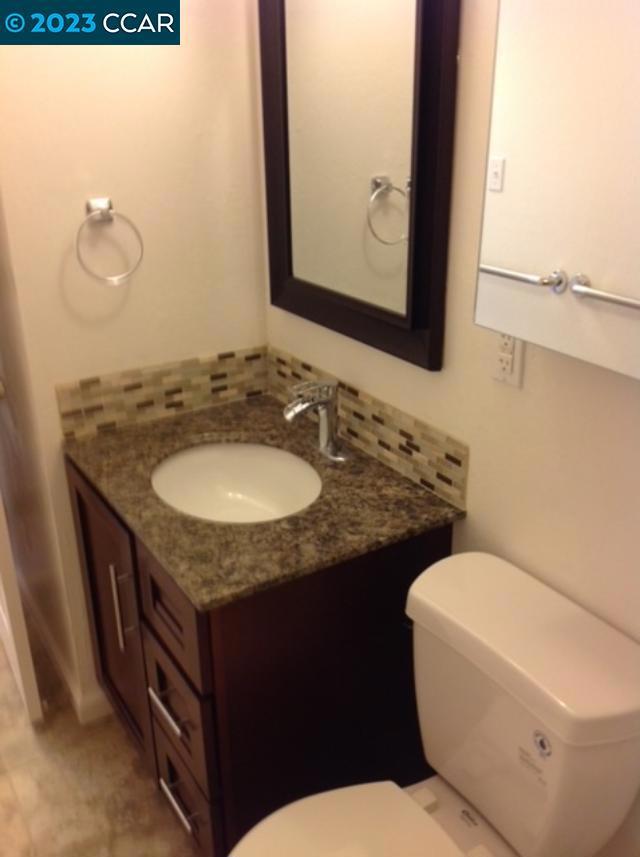 2019 Olivera Road Concord, CA 94520 - Photo 3 of 7 a bathroom with a granite countertop toilet sink and mirror