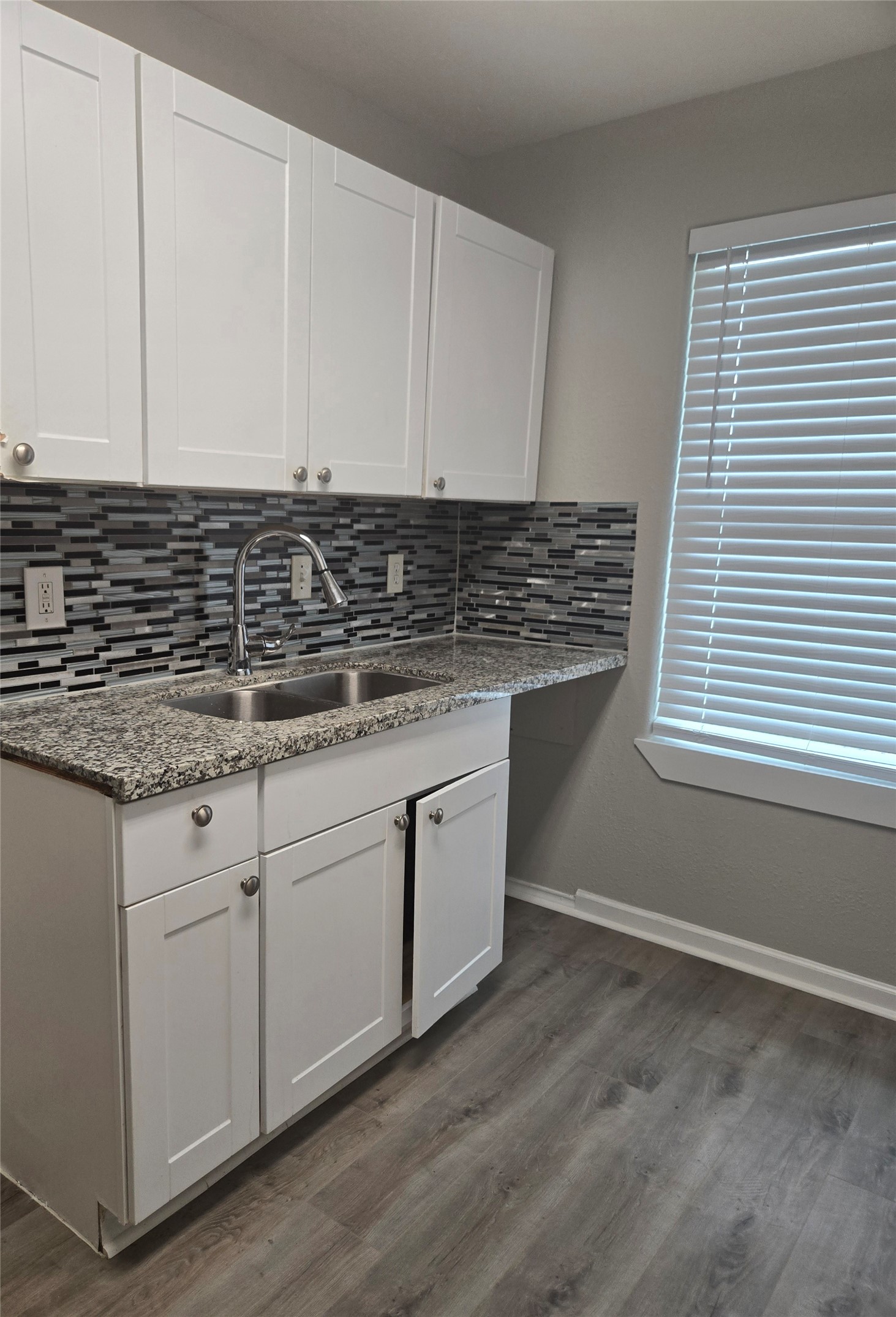 4834 Clover Street Houston, TX 77033 - Photo 4 of 10 a kitchen with granite countertop white cabinets and white appliances